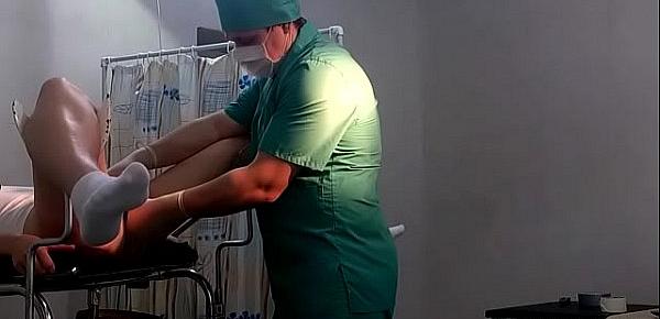  A girl in white socks on a gynecological chair